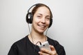 Smiling young girl with headphones listening to music from smartphone Royalty Free Stock Photo