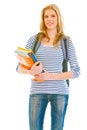 Smiling young girl holding schoolbooks in hands Royalty Free Stock Photo