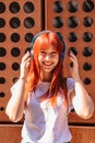 Girl listening to music on street in headphones Royalty Free Stock Photo