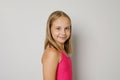 Smiling young girl portrait. Little kid posing on light gray studio background Royalty Free Stock Photo