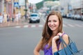 Smiling young girl shopping outdoors Royalty Free Stock Photo