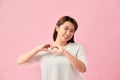 Smiling young girl showing heart with two hands, love sign Royalty Free Stock Photo