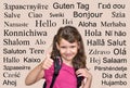 Smiling young girl with hello greeting in many different languages Royalty Free Stock Photo