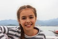 Smiling young girl sitting near by sea in Fethiye harbour Royalty Free Stock Photo