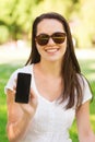 Smiling young girl with smartphone outdoors Royalty Free Stock Photo