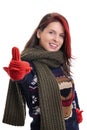 Smiling young girl in warm winter clothes giving thumbs up Royalty Free Stock Photo