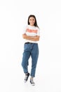 Smiling young girl wearing volunteer t-shirt standing