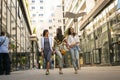 Smiling young girls walking on street with shopping bags. Royalty Free Stock Photo