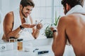 Smiling young guy preparing to shave his beard Royalty Free Stock Photo