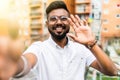 Smiling young guy taking selfie photo on smartphone on the street. Indian man using digital device. Selfie photo concept Royalty Free Stock Photo