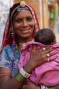 Smiling young gypsy woman and her baby