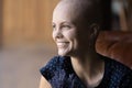 Smiling young hairless female suffering from cancer dreaming