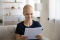 Smiling sick woman with cancer read good results in letter Royalty Free Stock Photo