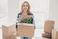 Smiling young happy woman moving new place of leaving and holdin Royalty Free Stock Photo