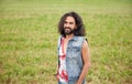 Smiling young hippie man on green field Royalty Free Stock Photo
