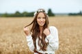 Smiling young hippie woman on cereal field