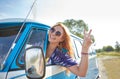 Smiling young hippie woman driving minivan car Royalty Free Stock Photo