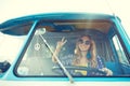 Smiling young hippie woman driving minivan car Royalty Free Stock Photo