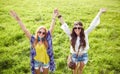 Smiling young hippie women dancing on green field Royalty Free Stock Photo