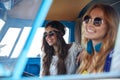 Smiling young hippie women driving minivan car Royalty Free Stock Photo