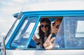 Smiling young hippie women driving minivan car Royalty Free Stock Photo