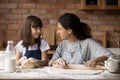 Happy Latino mom and small daughter baking at home Royalty Free Stock Photo