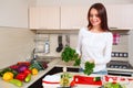 Smiling young housewife mixing fresh salad Royalty Free Stock Photo