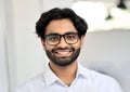 Smiling young indian business man wearing eyeglasses, headshot portrait. Royalty Free Stock Photo