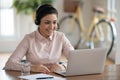 Happy millennial hindu businesswoman holding video business meeting in office. Royalty Free Stock Photo