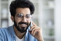 Smiling Young Indian Guy Wearing Eyeglasses Talking On Cellphone Royalty Free Stock Photo