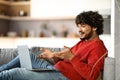Smiling Young Indian Man Making Video Call On Laptop At Home, Royalty Free Stock Photo