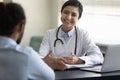 Smiling young Indian woman doctor consulting African American patient Royalty Free Stock Photo