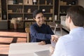 Smiling young Indian woman shaking hands with hr manager. Royalty Free Stock Photo