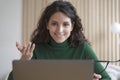 Smiling young Italian woman teacher tutor talks with students during online lesson on laptop