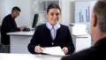 Smiling young job applicant giving curriculum vitae to hr manager, interview Royalty Free Stock Photo