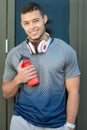 Smiling young latin man water bottle runner portrait format running sports training fitness Royalty Free Stock Photo