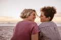 Smiling young lesbian couple enjoying a romantic beach sunset together Royalty Free Stock Photo