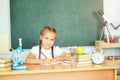 Smiling young little child girl writing in school. Education and Royalty Free Stock Photo