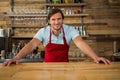 Smiling young male barista at counter in coffee shop Royalty Free Stock Photo