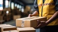 Smiling young male postal delivery courier man in front of cargo van delivering package Royalty Free Stock Photo