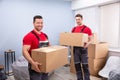 Smiling Young Male Relocation Worker Carrying Cardboard Boxes Royalty Free Stock Photo