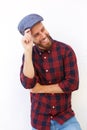 Smiling young man with beard and hat posing against white background Royalty Free Stock Photo