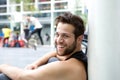 Smiling young man with beard sitting outside Royalty Free Stock Photo