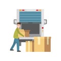 Smiling young man loads things packed in boxes into a truck Royalty Free Stock Photo