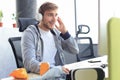 Smiling young man in casual clothing using computer, streaming playthrough or walkthrough video Royalty Free Stock Photo