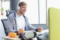 Smiling young man in casual clothing using computer, streaming playthrough or walkthrough video Royalty Free Stock Photo