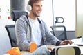 Smiling young man in casual clothing using computer, streaming playthrough or walkthrough video Royalty Free Stock Photo