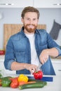 smiling young man chopping vegetables in home Royalty Free Stock Photo