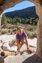 Man Climbing a Wooden Ladder at Bandelier National Monument Royalty Free Stock Photo