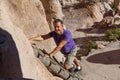 Man Climbing a Wooden Ladder at Bandelier National Monument Royalty Free Stock Photo